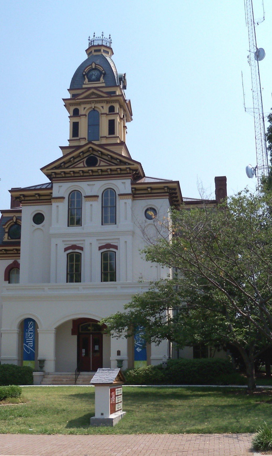 White Victorian Old Cabarrus County Courthouse in downtown Concord, North Carolina, with arched windows, a tiered clock tower and a domed cupola