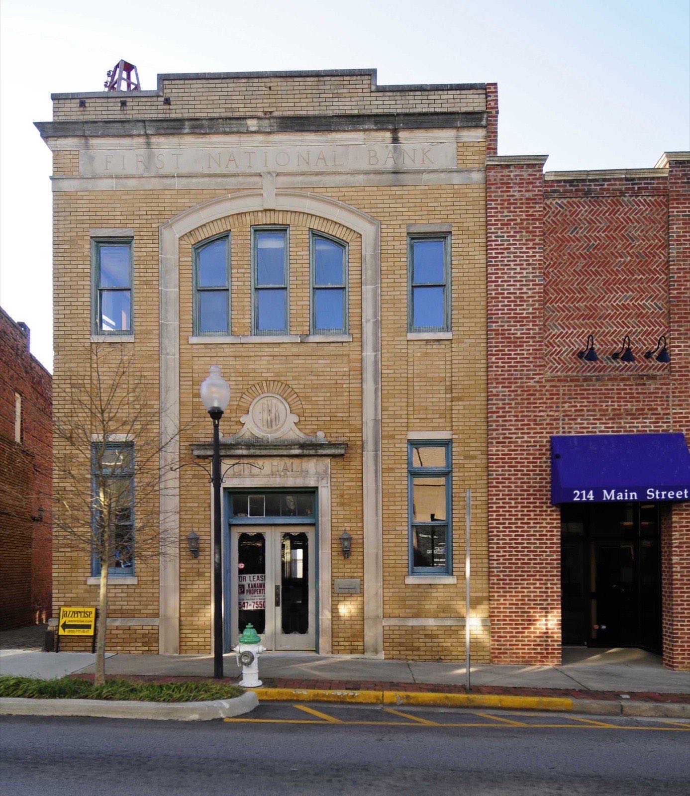 Historic tan brick First National Bank building with arched windows on Main Street in the Fort Mill, South Carolina downtown historic district